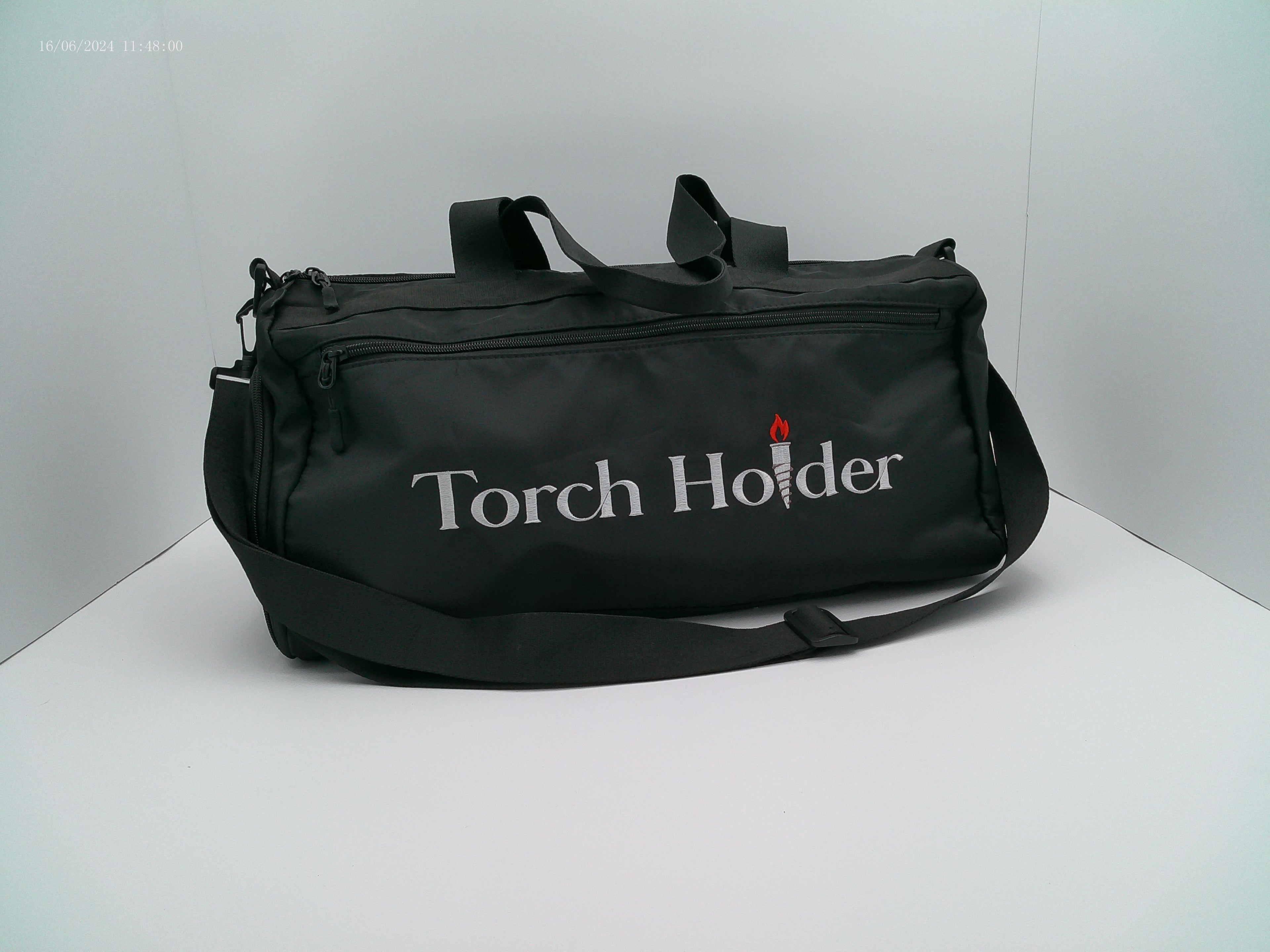 Black bag with 'Torch Holder' text on a white background