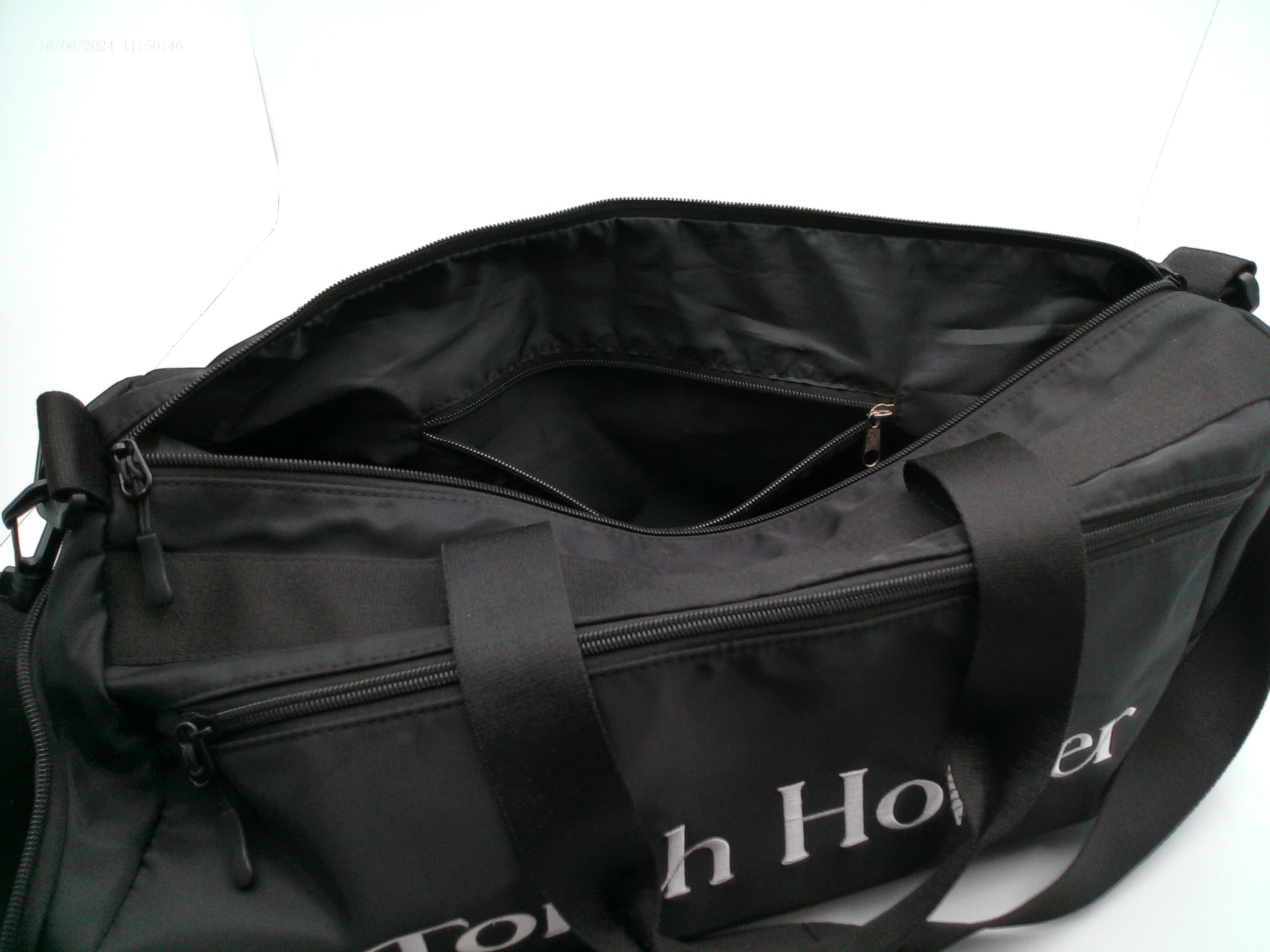 Opened Zippers on a Black duffel bag with 'Touch Holder' branding on a white background